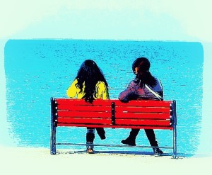 two women on a bench having an internalizing conversation 